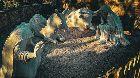 A statue of a man and a dog in a park